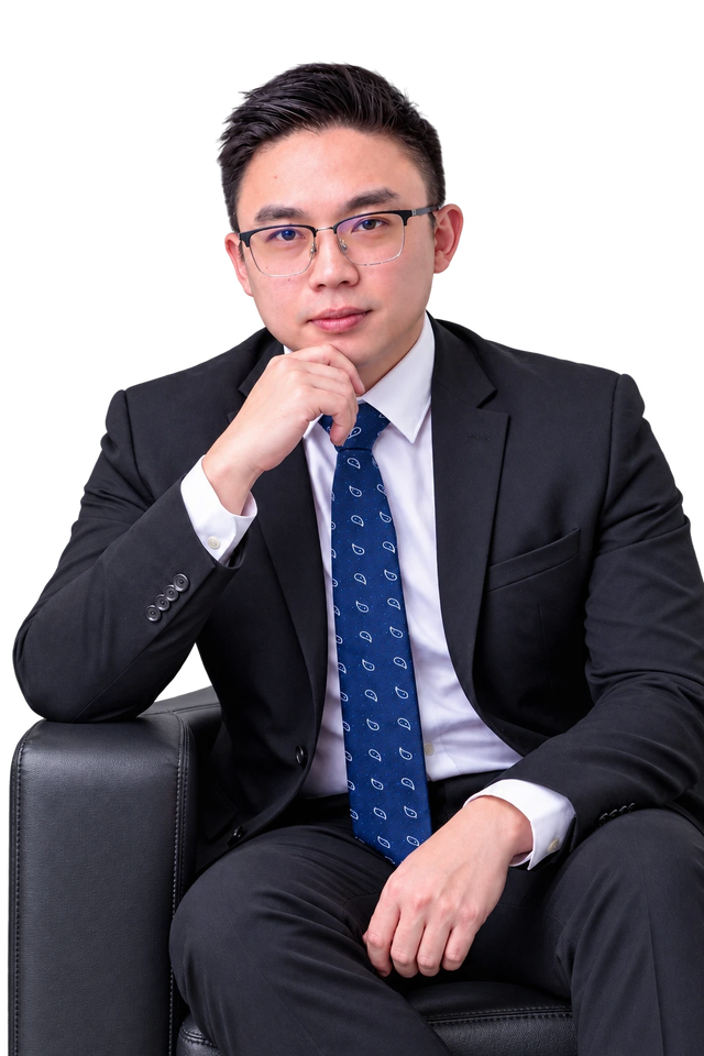 Isaac Foh, Registered Tax Agent in Melaka, seated in an armchair in a dark suit